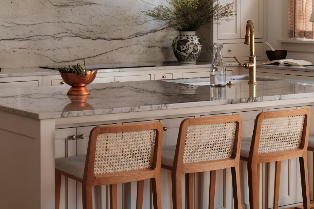 Kitchen island with marble countertop and rattan bar stools