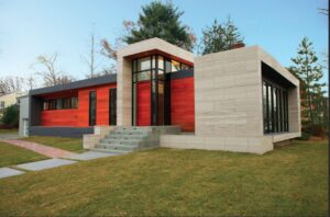 Modern home exterior with stone cladding, wood siding and floor-to-ceiling windows